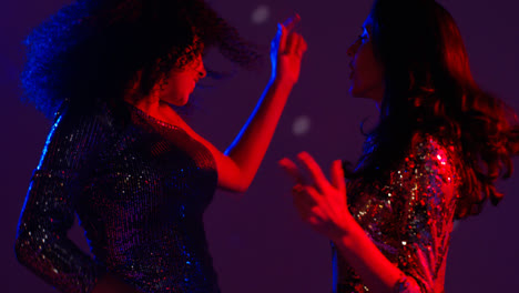 Close-Up-Of-Two-Women-In-Nightclub-Bar-Or-Disco-Dancing-With-Sparkling-Lights-17